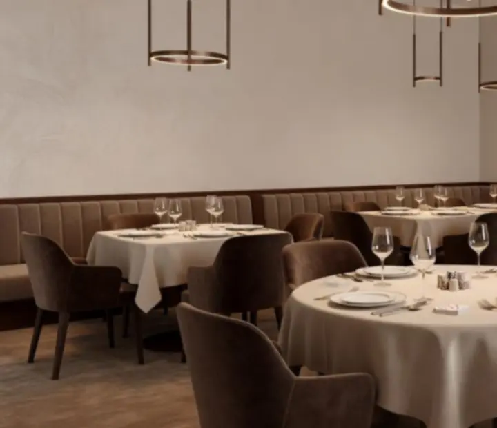 Jasne, eleganckie wnętrze restauracji De Hop B.V. z nakrytymi stołami i ciepłym oświetleniem